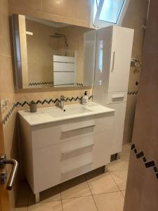 a white bathroom with a sink and a mirror at Poseidon Dreams Tenerife in Puerto de Santiago
