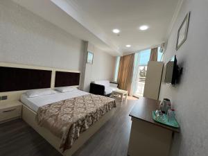 a hotel room with a bed and a desk at Baku Center inn NS in Baku
