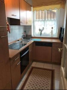 a kitchen with a sink and a stove and a window at Mühlenblick in Dänschendorf +2 photos