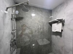 a bathroom with a shower with a glass door at Baku Center inn NS in Baku +28 photos