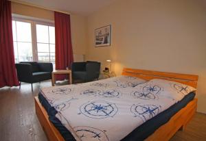 a bedroom with a bed and two chairs at Orth A5 in Orth +2 photos