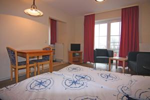 a living room with a bed and a desk and a room at Orth A5 in Orth