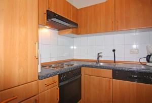 a kitchen with wooden cabinets and a sink and a stove at Orth A5 in Orth