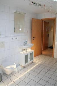 a bathroom with a sink and a toilet at Orther Hafenblick in Orth