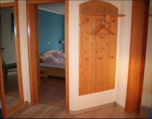 a room with a door and a bedroom with a bed at Orther Hafenblick in Orth +2 photos