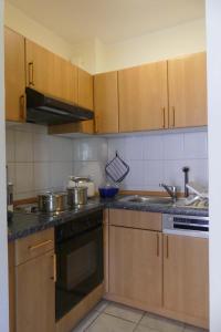 a kitchen with wooden cabinets and a stove and a sink at Orth - E37 in Orth