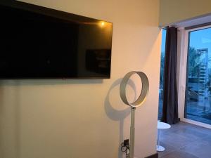 a flat screen tv hanging on a wall with a hoop at Villa Claus in Puerto Calero