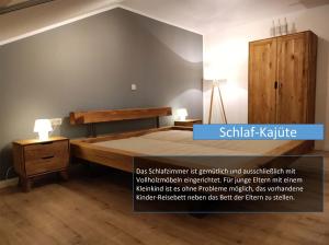 a bedroom with a large bed and a wooden cabinet at Hafenblick in Orth