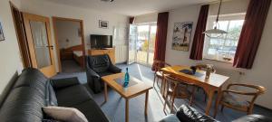 a living room with a couch and a table at Blue Water in Orth