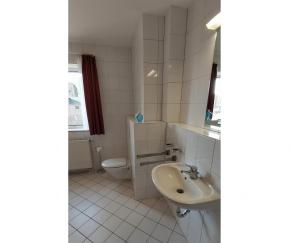 a white bathroom with a sink and a toilet at Blue Water in Orth +4 photos