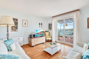 a living room with a white couch and a table at Porto sea view-Terrace & AC in Portovenere +18 photos