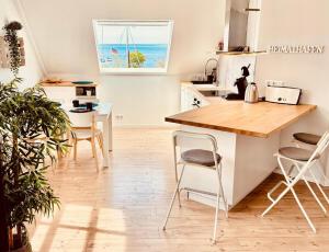 a kitchen with a counter and a table and chairs at meerBLICK in Orth