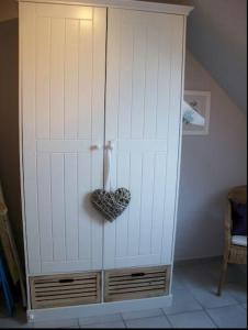 a large white cabinet in the corner of a room at Wohnung mit Balkon und Aussicht in Petersdorf auf Fehmarn