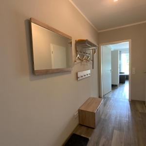 a living room with a mirror on the wall at Columbus in Petersdorf auf Fehmarn +2 photos
