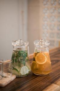Dos tarros de cristal llenos de limonada y naranjas sobre una mesa de madera en Cashew Inn, en Ho Chi Minh