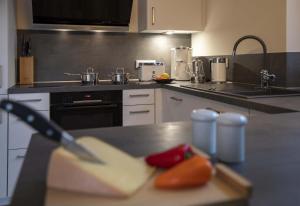 a kitchen with a counter with a knife and some food at Marco Polo in Petersdorf auf Fehmarn