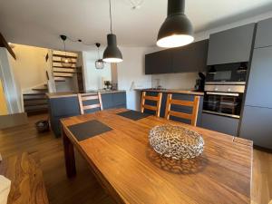 a kitchen and dining room with a wooden table at Little Welcome in Petersdorf auf Fehmarn