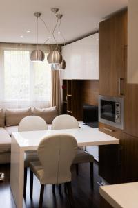 a kitchen and living room with a table and chairs at Lozenets Apartment in Sofia