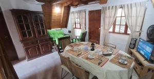 a dining room with a table and a television at Velero de Mar in Las Grutas