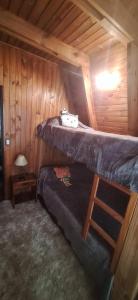 a bedroom with two bunk beds in a cabin at Velero de Mar in Las Grutas
