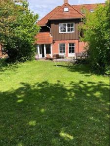 a house with a large yard in front of it at Lieblingsplatz in Petersdorf auf Fehmarn