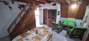 a dining room with a table and green chairs at Velero de Mar in Las Grutas +10 photos