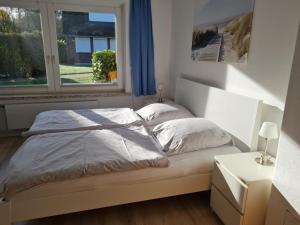 ein Bett in einem Schlafzimmer mit Fenster in der Unterkunft Inselzeit in Vitzdorf