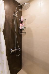 a bathroom with a shower with a shower head at Lozenets Apartment in Sofia +14 photos