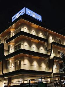 a building with a sign on top of it at Royal Raven Hotel & Banquet' Greater Noida in Greater Noida