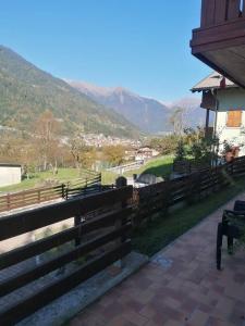 a wooden fence with a view of a mountain at MountainHome Garage and Free Parking in Bocenago