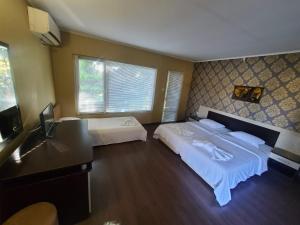 a hotel room with two beds and a desk at Комплекс Хиподрума in Dobrich
