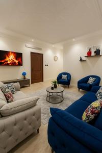 a living room with two couches and a fire on the wall at غرفه وصاله بدخول ذاتي in Jeddah