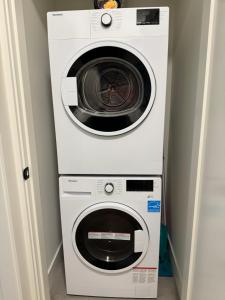 a washing machine and a dryer in a room at Beautiful 2 Bedroom suite in White Rock