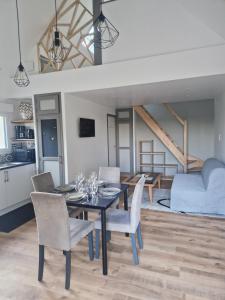 a kitchen and dining room with a table and chairs at Baie du Mont Saint Michel, petite maison neuve in Pontorson