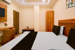 a hotel room with a bed and a television at Townhouse Gomti Nagar Station Formerly Budget In in Gomti Nagar +15 photos