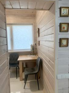 a small room with a table and two chairs at Еко апартаменти DOM Art in Ovruch