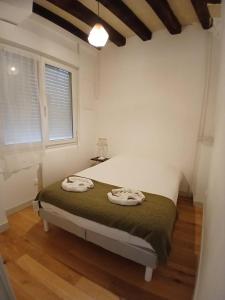 a bedroom with a bed in a room with a window at T2 Centre ville - rdc in Angers