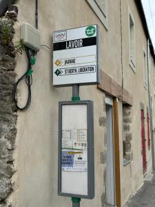 a street sign on a pole in front of a building at Apartee - Charmant T2 en centre ville de Laval in Laval