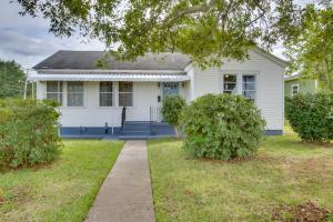 a white house with a sidewalk in front of it at Charming Cottage with Mississippi River Views! in Natchez