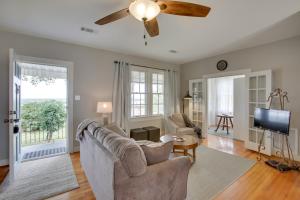 a living room with a couch and a ceiling fan at Charming Cottage with Mississippi River Views! in Natchez