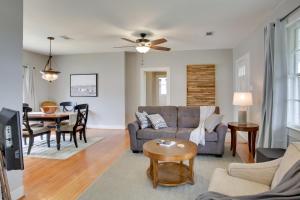 a living room with a couch and a table at Charming Cottage with Mississippi River Views! in Natchez