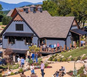 a group of people standing outside of a large building at Sip Sip Hooray at Eagles Nest in Elk Park