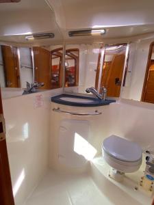 a bathroom with a toilet and a sink at Boat - Yoga and sailing retreat in Marigot