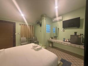 a hospital room with a bed and a tv at Khlong bang phra boutique hotel in Trat