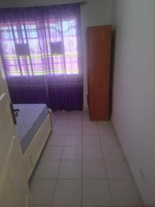 a small room with a bed and a window at Sabel's Retreat in Elephant Island