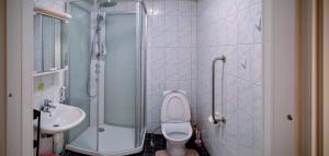 a bathroom with a shower and a toilet and a sink at Pink Nissi in Kuusamo +8 photos