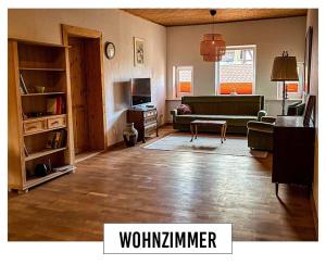 a living room with a couch and a table at Landhaus in Springe