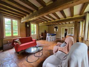 a living room with two couches and a table at Détente absolue et piscine chauffée 