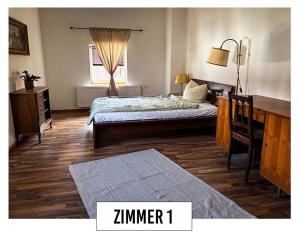 a bedroom with a bed and a desk and a window at Landhaus in Springe