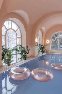 a bathroom with three sinks in a swimming pool at the eighteen86 by keyone in Bad Gastein